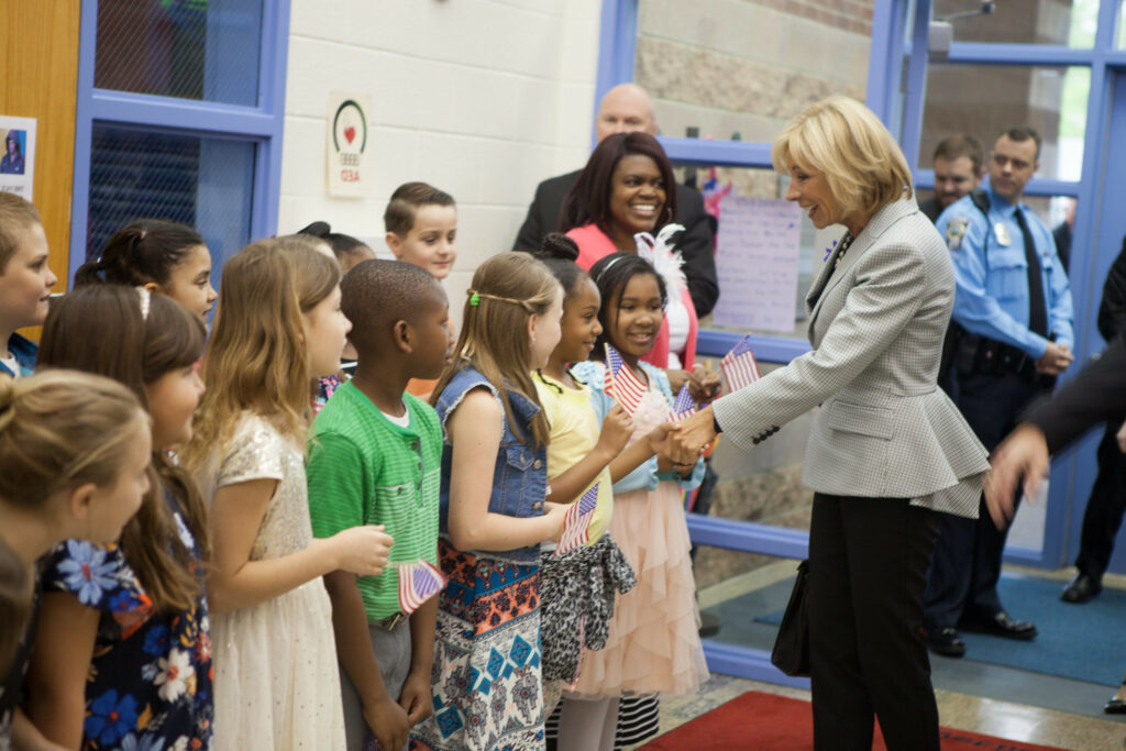 Betsy DeVos greets students while serving as U.S. Secretary of Education