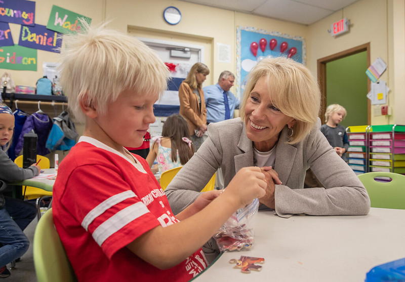 Betsy DeVos with a student at the American Charter Academy in Mat-Su Valley in Alaska